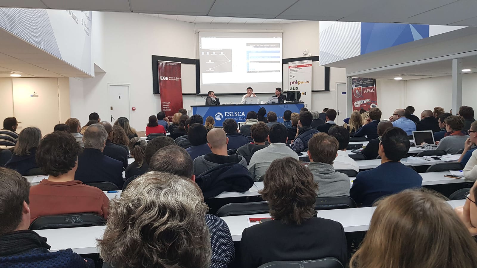 Audience at a Club Cyber AEGE conference with Éric Chambareau of Airbus CyberSecurity at the École de Guerre Économique