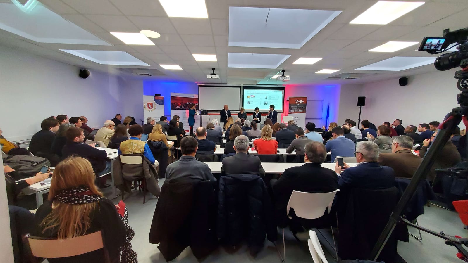 Audience and panel at a Cyber-Day.Info conference at the École de Guerre Économique in Paris