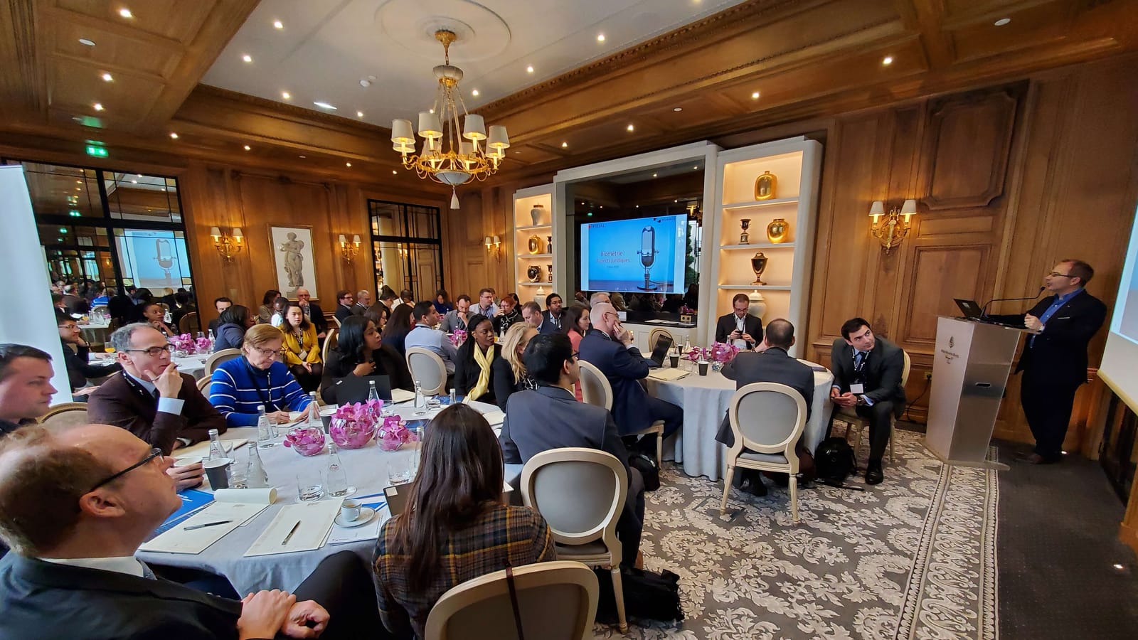 Participants seated at round tables during an ISMG cybersecurity roundtable in Paris